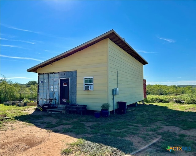 rear view of property with a lawn