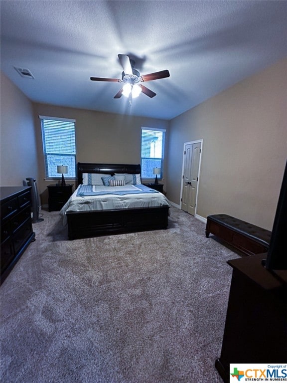 carpeted bedroom with a textured ceiling and ceiling fan