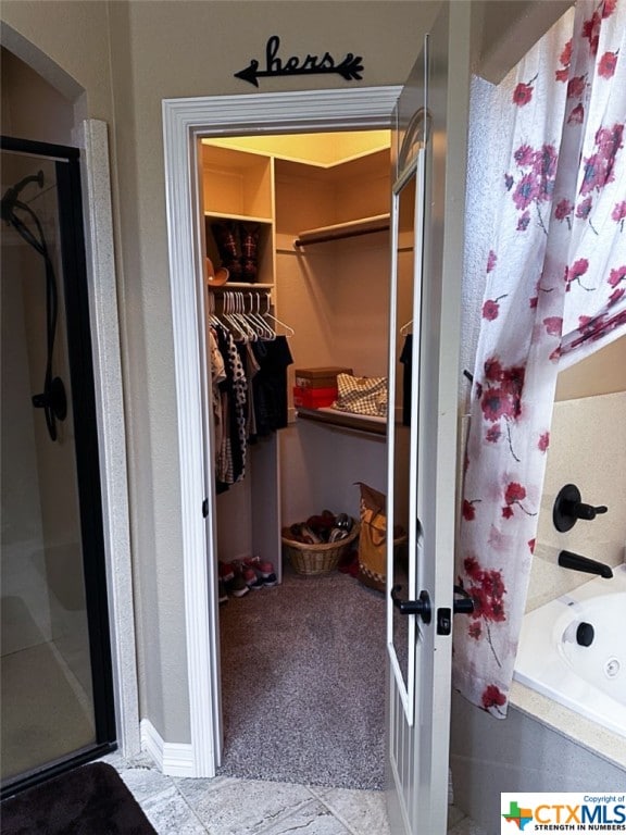 bathroom featuring separate shower and tub