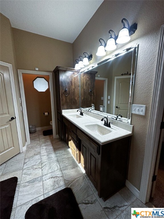 bathroom featuring toilet and vanity