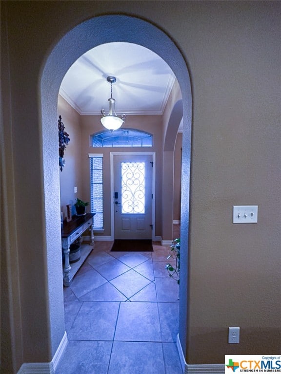 tiled foyer with ornamental molding