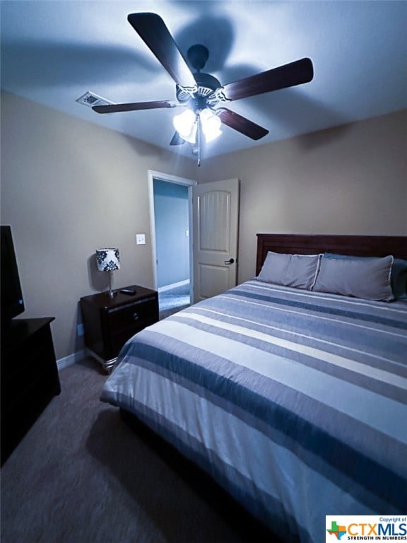 bedroom featuring ceiling fan and dark colored carpet