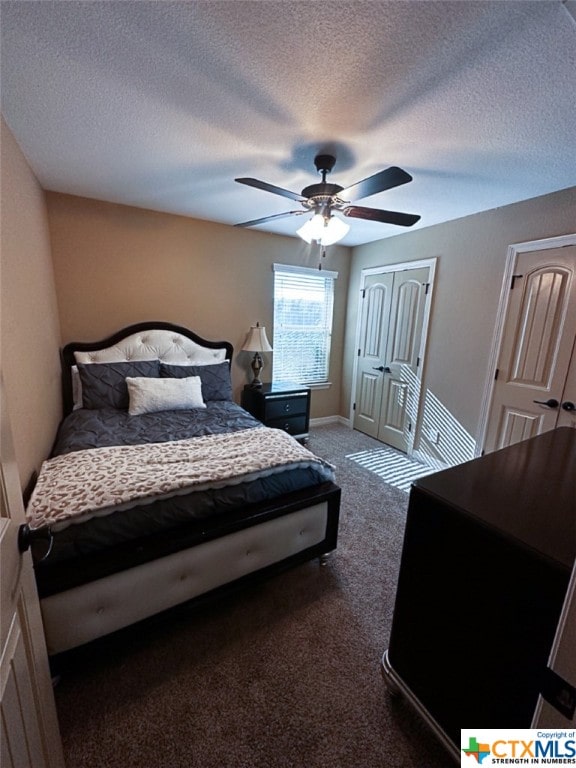 carpeted bedroom with ceiling fan and a textured ceiling