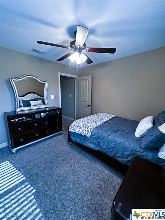 carpeted bedroom featuring a textured ceiling and ceiling fan