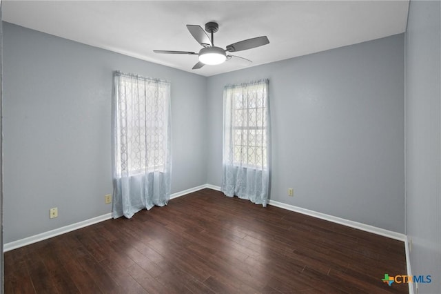 spare room with a ceiling fan, wood finished floors, and baseboards