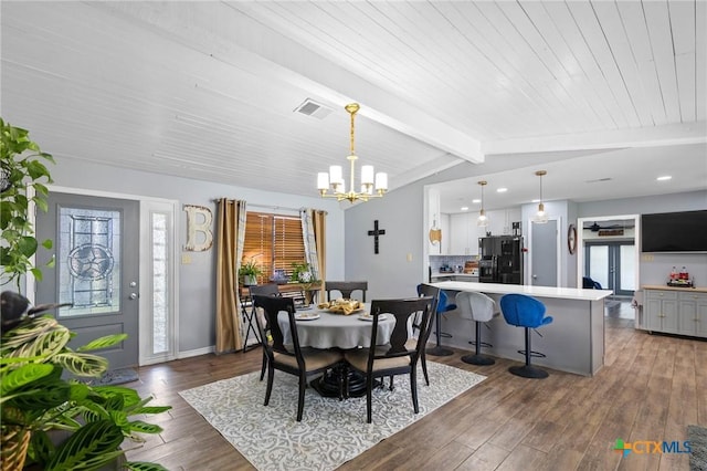 dining space featuring baseboards, visible vents, vaulted ceiling with beams, dark wood-type flooring, and a chandelier