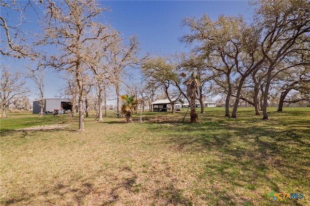 view of yard with an outbuilding and a pole building