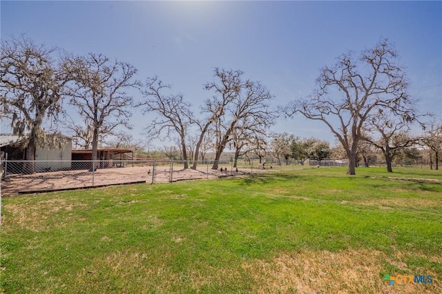 view of yard with an outbuilding and fence