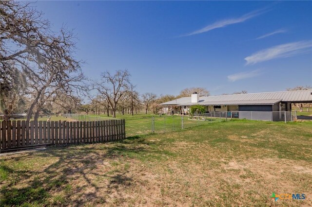 view of yard featuring an outbuilding and fence