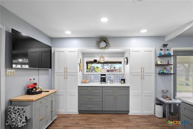 kitchen featuring open shelves, wood finish floors, recessed lighting, and gray cabinetry