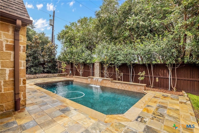 view of pool with a patio and pool water feature