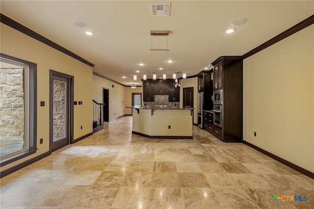 kitchen featuring a center island with sink, dark brown cabinets, pendant lighting, decorative backsplash, and a breakfast bar area