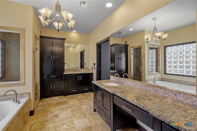 bathroom with vanity, separate shower and tub, and a notable chandelier