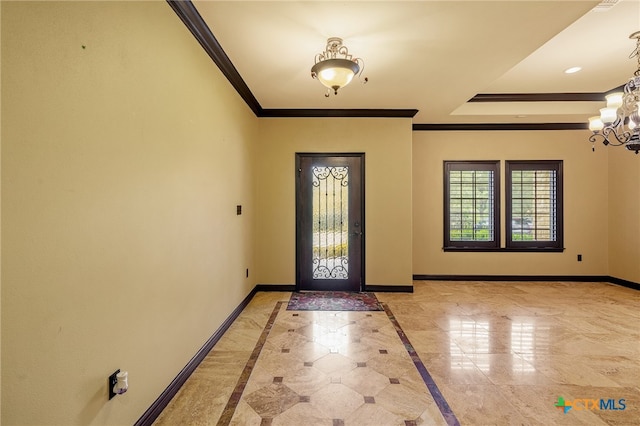 foyer featuring crown molding and a notable chandelier