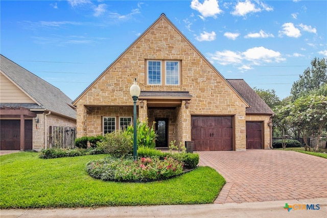 view of front of house featuring a garage and a front lawn