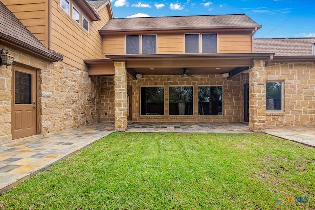 back of house featuring a patio, a yard, and ceiling fan