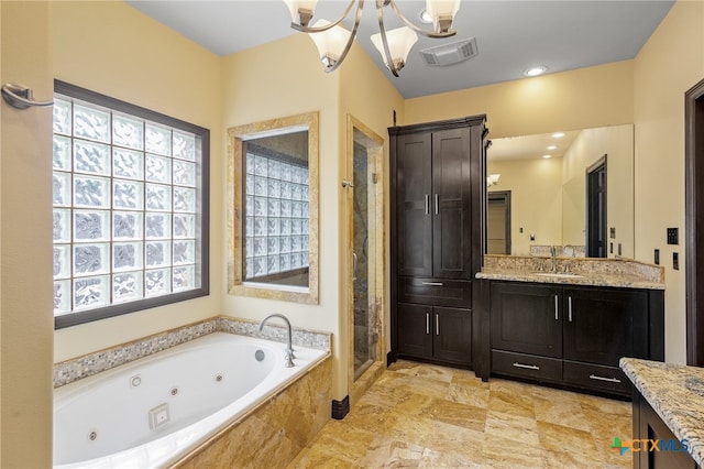 bathroom featuring shower with separate bathtub, vanity, and a healthy amount of sunlight