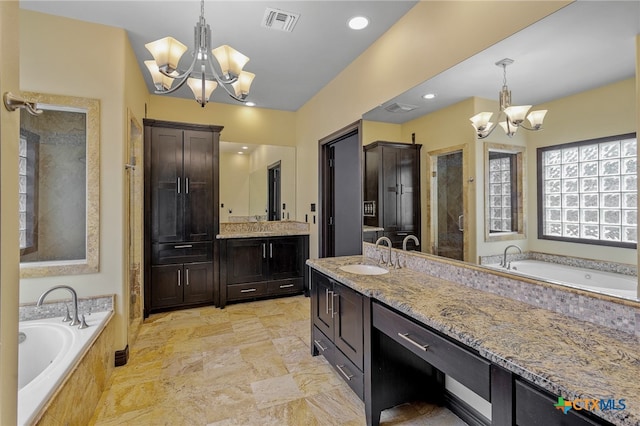 bathroom featuring independent shower and bath, vanity, and an inviting chandelier