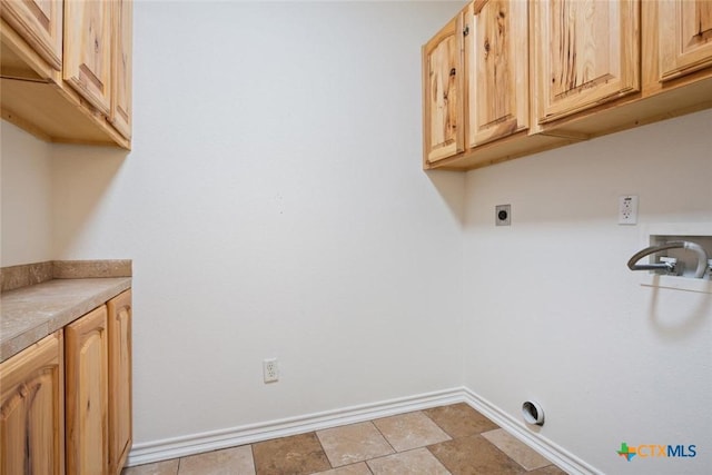 laundry area with hookup for an electric dryer, washer hookup, and cabinets