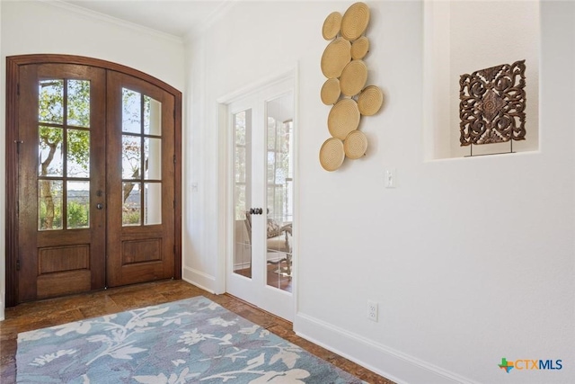 foyer featuring ornamental molding and french doors