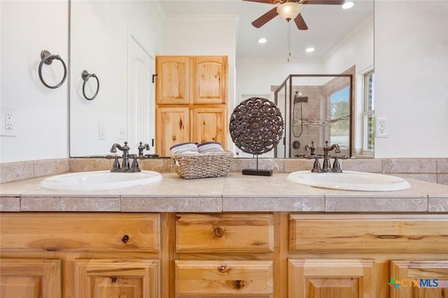 bathroom with vanity, ceiling fan, a shower with door, and ornamental molding