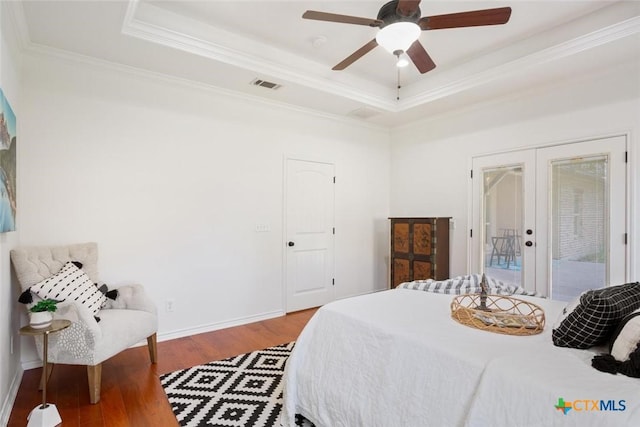 bedroom with access to exterior, french doors, a raised ceiling, and ceiling fan