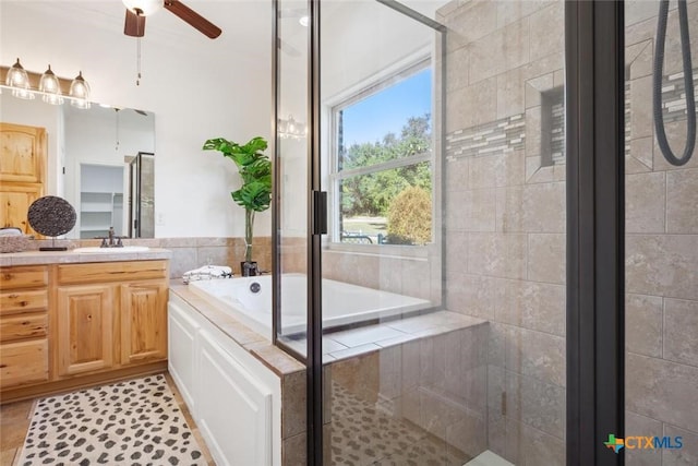 bathroom with shower with separate bathtub, vanity, tile patterned floors, and ceiling fan