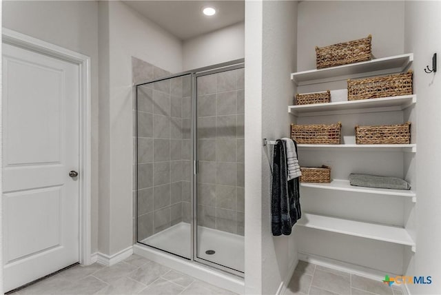 391 Walnut Crk, New Braunfels, TX 78130 - full bath with a stall shower, baseboards, and tile patterned floors