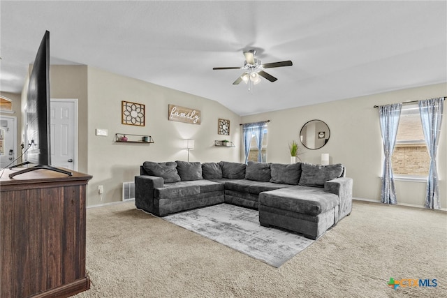 carpeted living room with lofted ceiling and ceiling fan