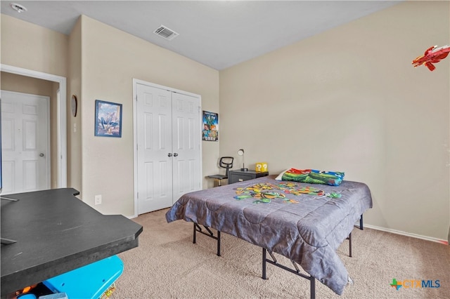 bedroom featuring light colored carpet and a closet