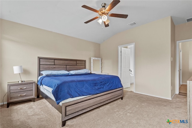 bedroom with ceiling fan, connected bathroom, light carpet, and lofted ceiling