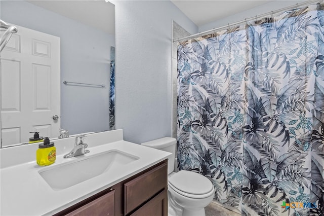 bathroom featuring toilet, a shower with curtain, and vanity