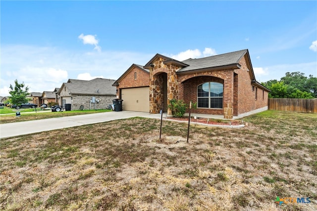 view of front of home featuring a garage and a front lawn