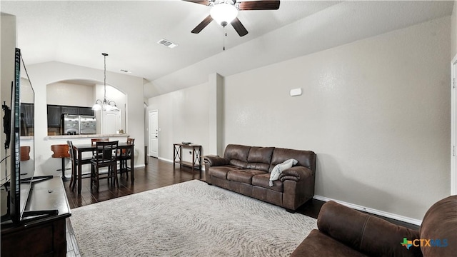 557/561 Creekside Cir, New Braunfels, TX 78130 - living area with ceiling fan, dark wood-style flooring, lofted ceiling, arched walkways, and a chandelier