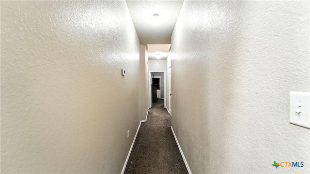 557/561 Creekside Cir, New Braunfels, TX 78130 - corridor featuring dark colored carpet and a textured wall