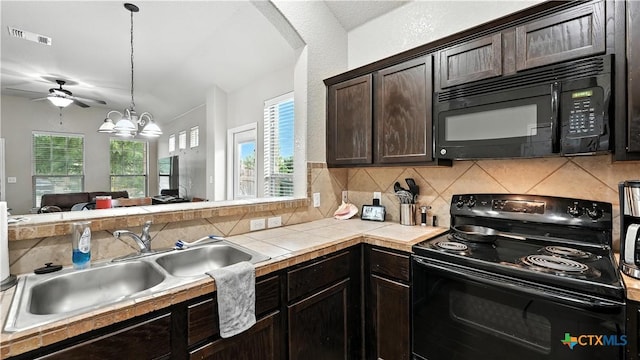 557/561 Creekside Cir, New Braunfels, TX 78130 - kitchen with black appliances, dark brown cabinets, decorative backsplash, ceiling fan, and open floor plan