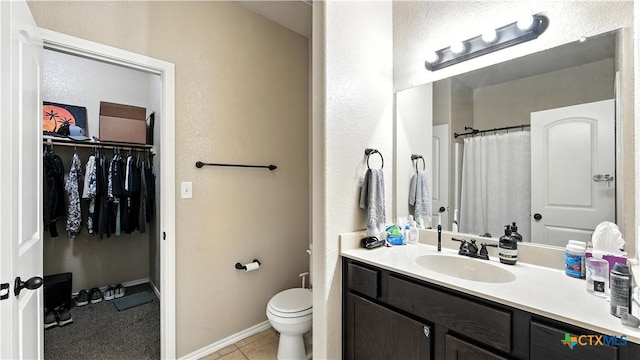 557/561 Creekside Cir, New Braunfels, TX 78130 - bathroom featuring vanity, a spacious closet, tile patterned floors, and a shower with shower curtain