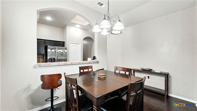 557/561 Creekside Cir, New Braunfels, TX 78130 - dining area featuring arched walkways, a chandelier, dark wood-style flooring, and recessed lighting