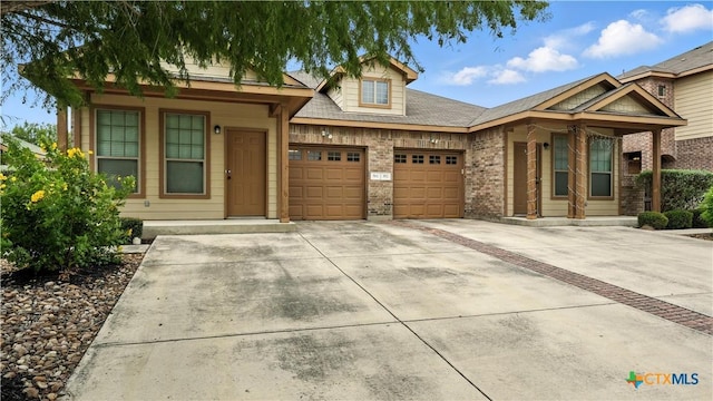 557/561 Creekside Cir, New Braunfels, TX 78130 - view of front of home featuring a garage, concrete driveway, covered porch, and brick siding