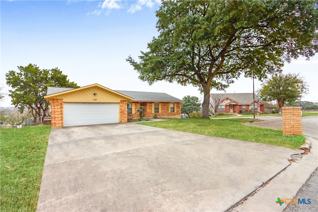 ranch-style home with a front yard and a garage