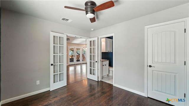 543 Scenic Terrace Dr, Canyon Lake, TX 78133 - unfurnished bedroom with french doors, wood finished floors, and connected bathroom