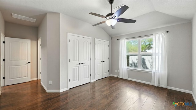 543 Scenic Terrace Dr, Canyon Lake, TX 78133 - unfurnished bedroom with two closets, vaulted ceiling, wood finished floors, and ceiling fan