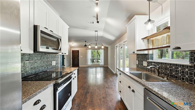 543 Scenic Terrace Dr, Canyon Lake, TX 78133 - kitchen with appliances with stainless steel finishes, lofted ceiling, a ceiling fan, white cabinets, and backsplash