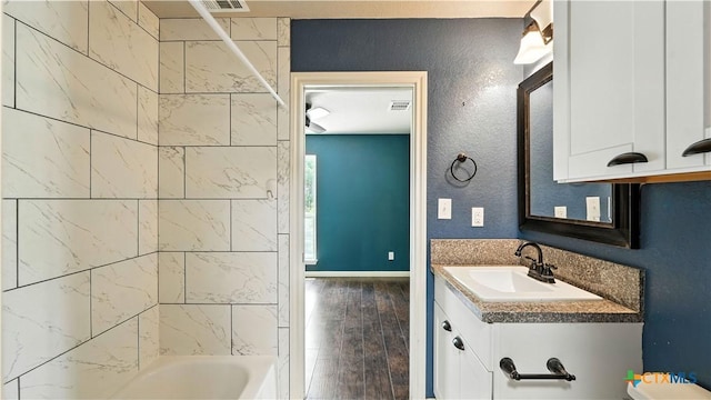 543 Scenic Terrace Dr, Canyon Lake, TX 78133 - bathroom featuring vanity, wood finished floors, and washtub / shower combination