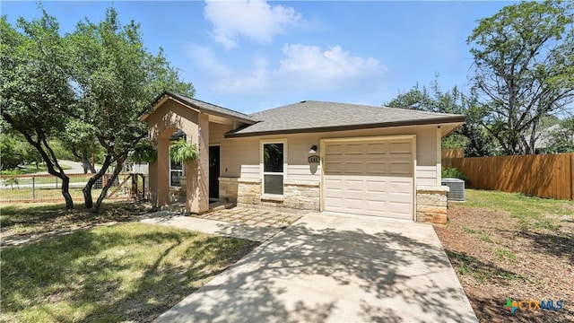 543 Scenic Terrace Dr, Canyon Lake, TX 78133 - view of front of property with an attached garage, a shingled roof, concrete driveway, and stone siding