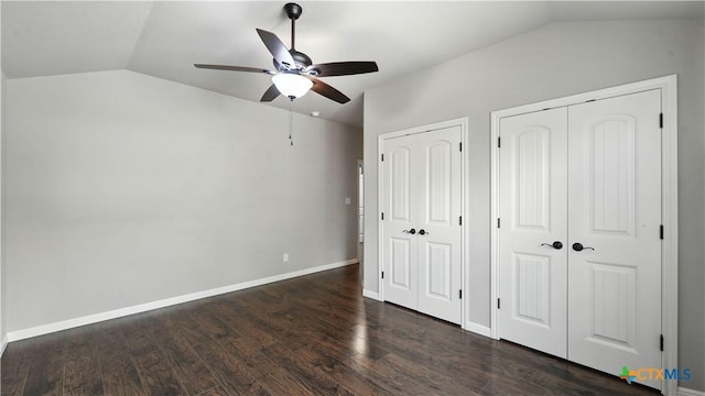 543 Scenic Terrace Dr, Canyon Lake, TX 78133 - unfurnished bedroom with lofted ceiling, multiple closets, dark wood-style floors, and ceiling fan