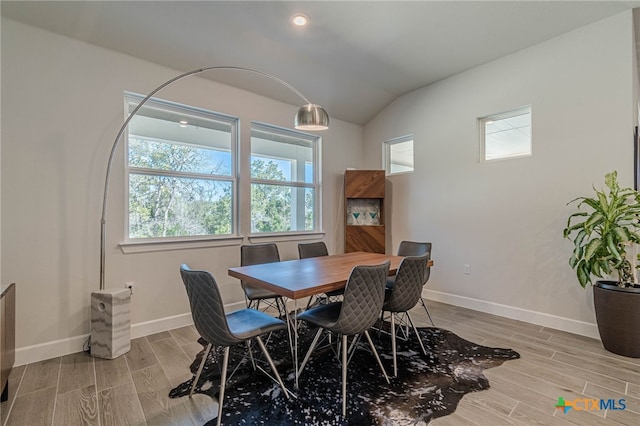 dining space with vaulted ceiling