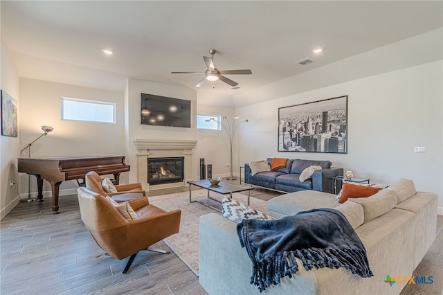 living room featuring ceiling fan and light hardwood / wood-style flooring