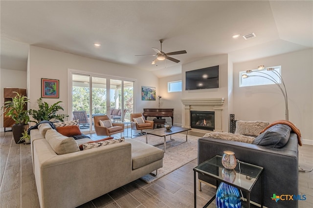 living room featuring ceiling fan, lofted ceiling, and hardwood / wood-style floors