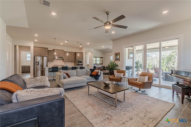 living room featuring ceiling fan and light wood-type flooring